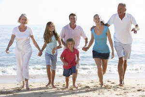 Three Generation Family Having Fun On Beach